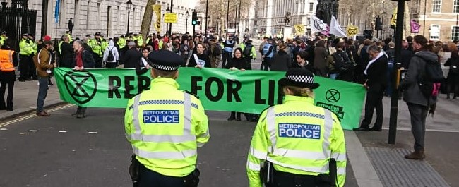 XR protest with two police in front of protestors